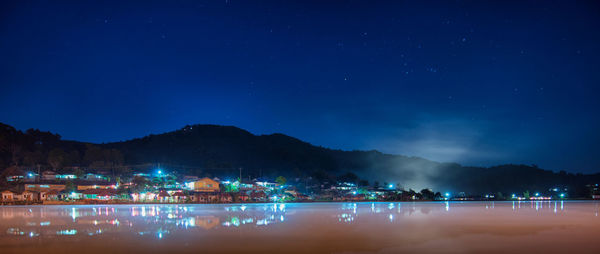 Scenic view of lake against blue sky at night