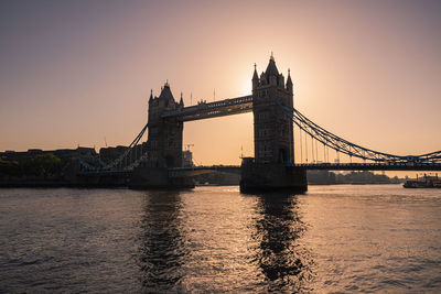 View of bridge over river during sunset