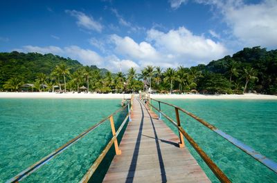 Scenic view of swimming pool by sea against sky