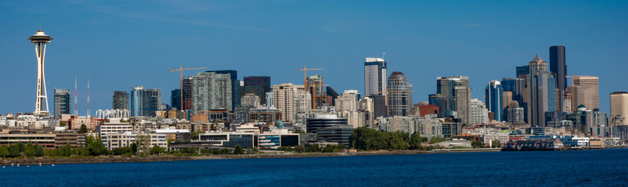 Modern buildings in city against blue sky