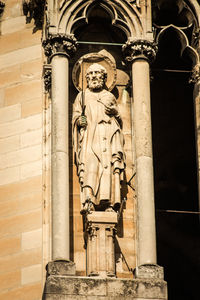 Statue of buddha against building