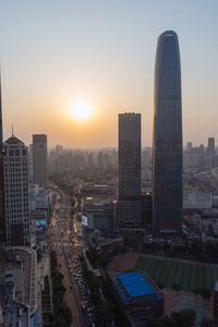 High angle view of buildings in city during sunset