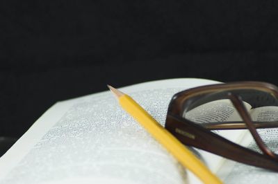 Close-up of book on table against black background