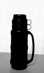 Close-up of coffee cup on table against white background