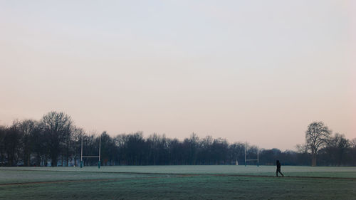 Scenic view of grassy field against sky