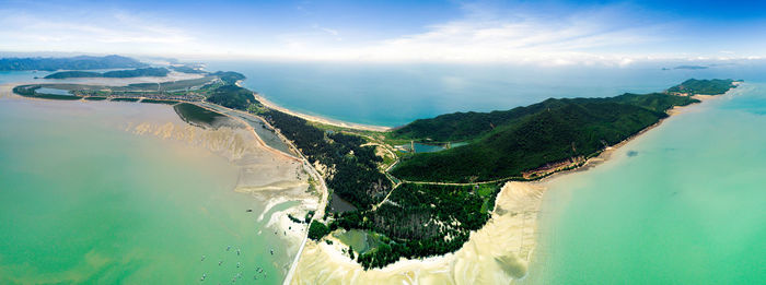 Aerial view of sea and mountains against sky