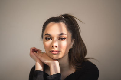 Close-up of young woman against wall