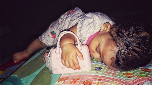 High angle view of girl lying on bed at home