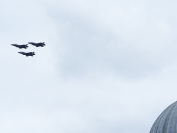 Low angle view of airplanes flying in sky