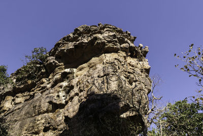 Low angle view of mountain against clear blue sky