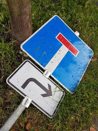 High angle view of road sign on field