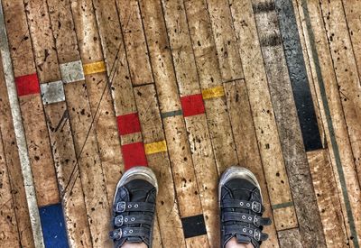 Low section of person standing on tiled floor