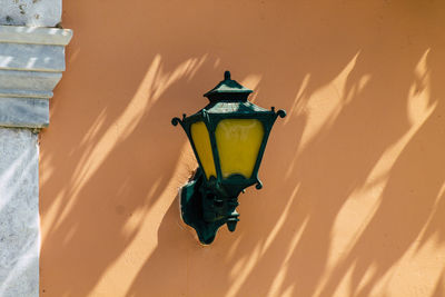 Close-up of electric lamp on wall