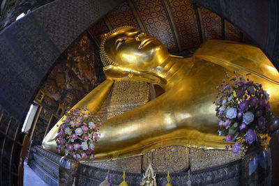 Close-up of golden buddha statue in temple