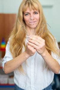 Portrait of smiling young woman drinking glass