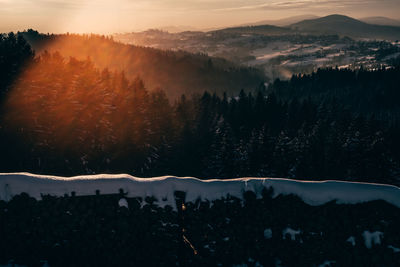 Scenic view of snowcapped mountains against sky during sunset