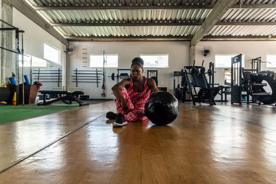 Side view of woman exercising in gym