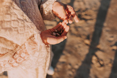 High angle view of woman hand holding leaf