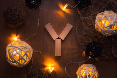 Directly above shot of letter y blocks and illuminated lights on wooden table