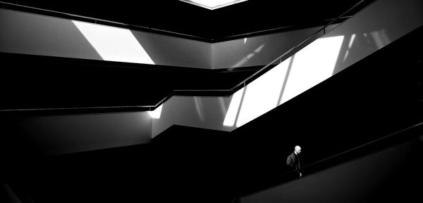 Side view of man walking on steps in building