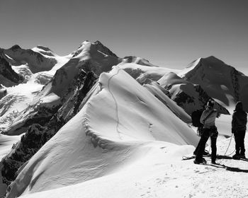 Low angle view of snowcapped mountain against clear sky