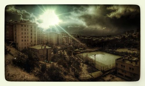Buildings against cloudy sky