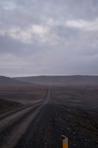 Road by landscape against sky