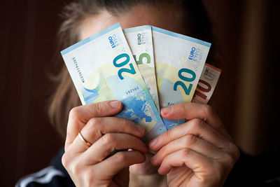 Close-up of woman holding european union currency