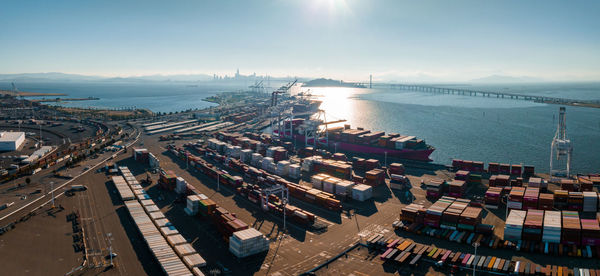 The oakland outer harbor aerial view. loaded trucks moving by container cranes.