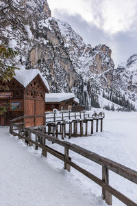 Built structure on snow covered landscape against sky