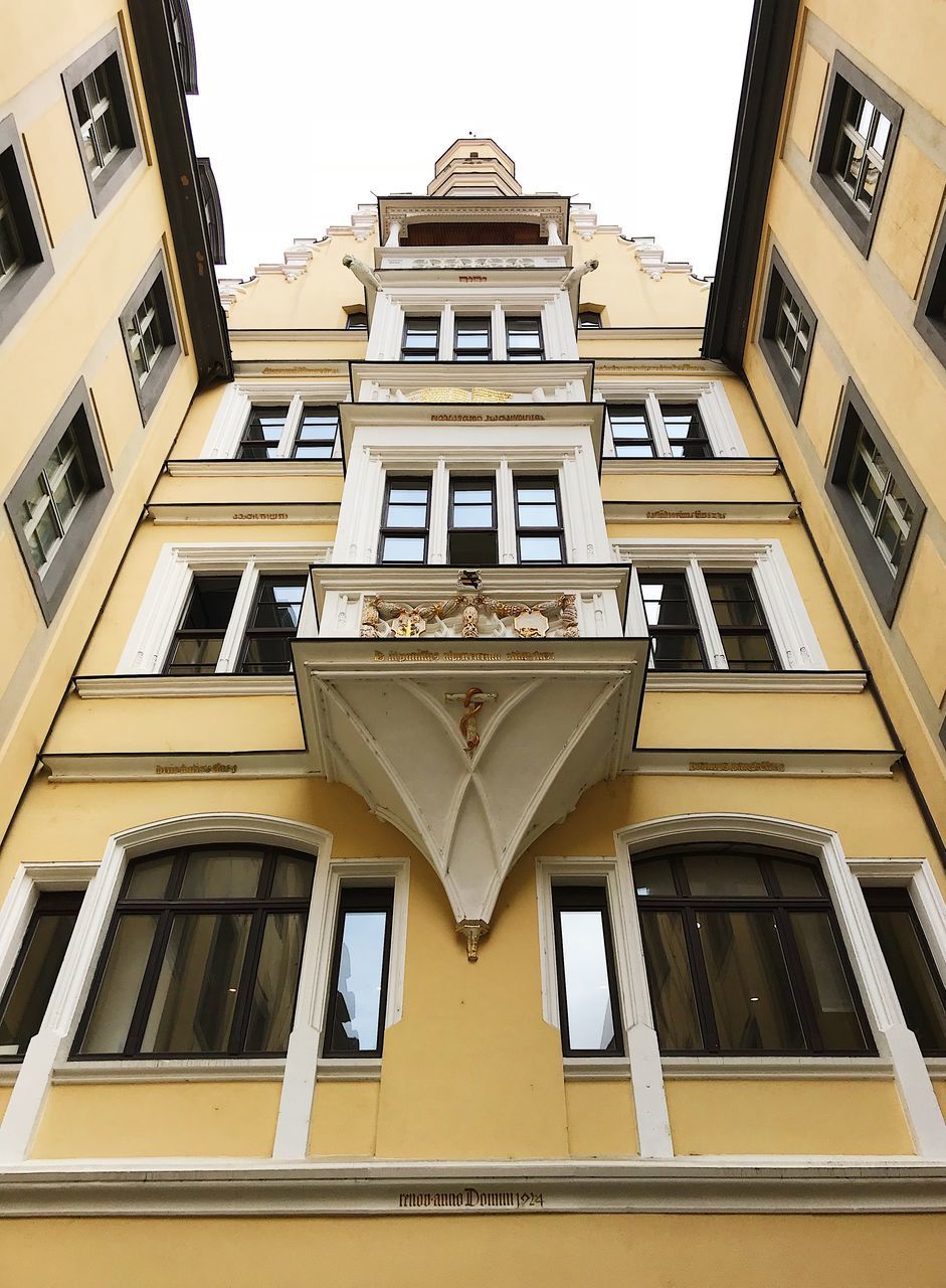 LOW ANGLE VIEW OF YELLOW BUILDING AGAINST SKY
