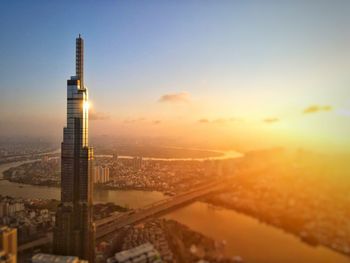 Aerial view of buildings in city during sunset