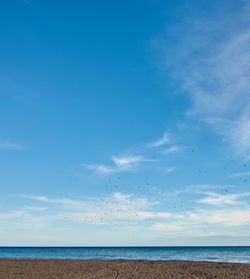 Scenic view of sea against blue sky