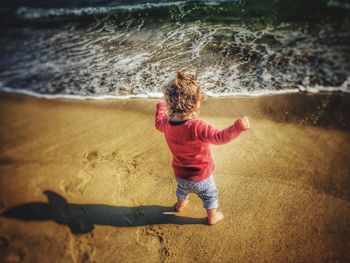 Full length of boy playing on beach