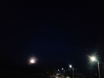 Low angle view of illuminated street light at night