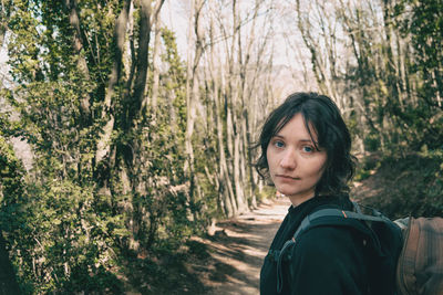 Portrait of woman standing in forest