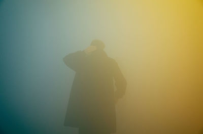 Rear view of man in foggy weather