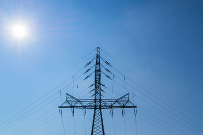 Low angle view of electricity pylon against sky