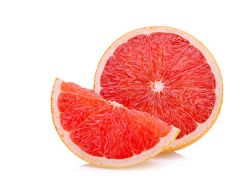 Close-up of orange slices over white background