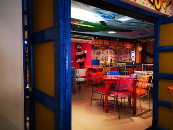 Empty chairs and tables in restaurant