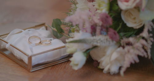 Close-up of wedding rings on table