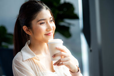 Young woman drinking glass