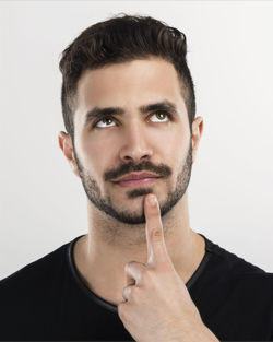 Portrait of young man against white background