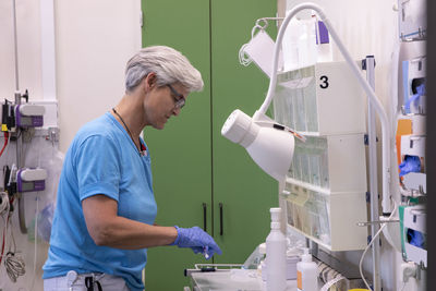 Side view female doctor working at table in hospital