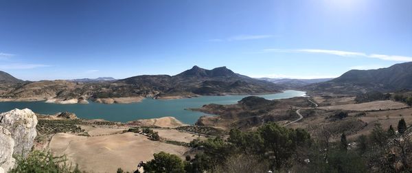 Panoramic view of sea and mountains against sky