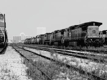 Train on railroad tracks against clear sky