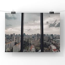 Buildings against sky seen through glass window