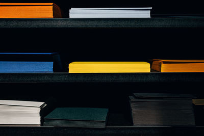 View of multi colored files on shelf