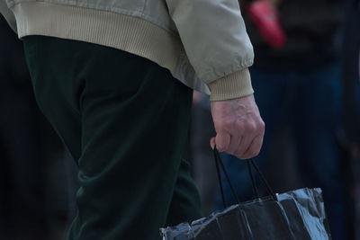 Close-up of man standing in hand