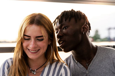 Portrait of an engaged multiethnic couple having fun on summer vacation on a river cruise ship